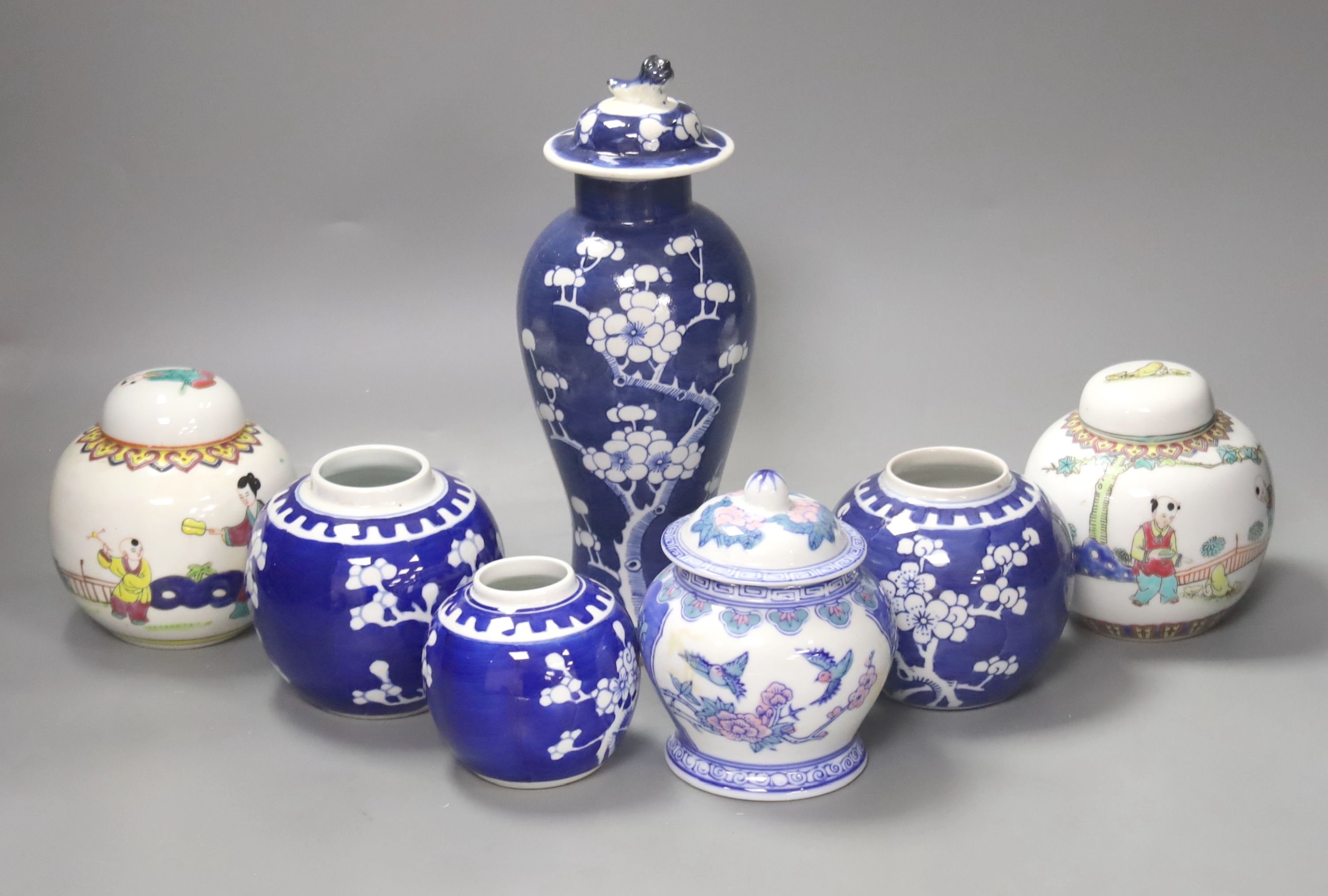 Two pairs of Chinese jars, one pair with covers, two other jars and a blue and white vase and cover, height 26cm